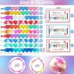Colorful AYGXU heart-shaped pop fidget bracelets displayed with Valentine's Day cards for kids' exchanges.