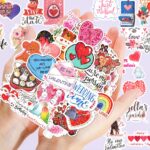 A pile of 100 BestiePal holographic Valentine's Day heart stickers with various romantic messages and patterns, reflecting ra