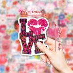 A pile of 100 BestiePal holographic Valentine's Day heart stickers with various romantic messages and patterns, reflecting ra