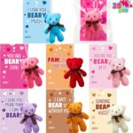 A collection of 28 mini plush bear toys in red, pink, and white, each paired with a unique Valentine's Day card.