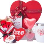 Red heart-shaped gift box open to reveal a 12 oz insulated tumbler, bath bomb, mirror, soap roses, and other spa items.