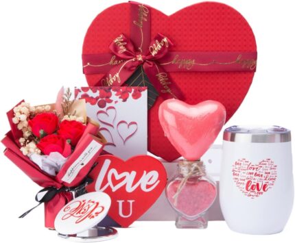 Red heart-shaped gift box open to reveal a 12 oz insulated tumbler, bath bomb, mirror, soap roses, and other spa items.