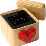 Lovebox Black & White Love Note Messenger with a red pixel heart spinning on the front, made of wood.