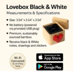 Lovebox Black & White Love Note Messenger with a red pixel heart spinning on the front, made of wood.