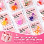 A pile of 24 small, colorful Valentines-themed squishy stress balls featuring various designs like hearts and cute characters