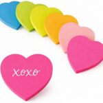 A stack of multicolor OHOME heart sticky notes, showcasing dark blue, light pink, neon green, orange, bright green, and hot p