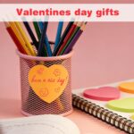 A stack of multicolor OHOME heart sticky notes, showcasing dark blue, light pink, neon green, orange, bright green, and hot p