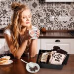 Vabean 5-Piece Coffee Gift Basket with ceramic mug, spoon, spoon rest, coffee candle, and patterned socks in a gift box.