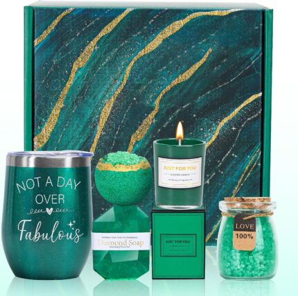An emerald green spa gift basket featuring a bath bomb, body salt, candle, gem soap, and a stainless steel wine mug.