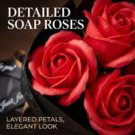 A vibrant red artificial rose bouquet featuring three realistic soap flower blooms with green faux silk leaves, arranged in a